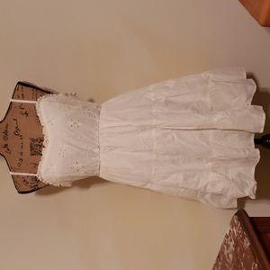 Cream colored flirty dress.